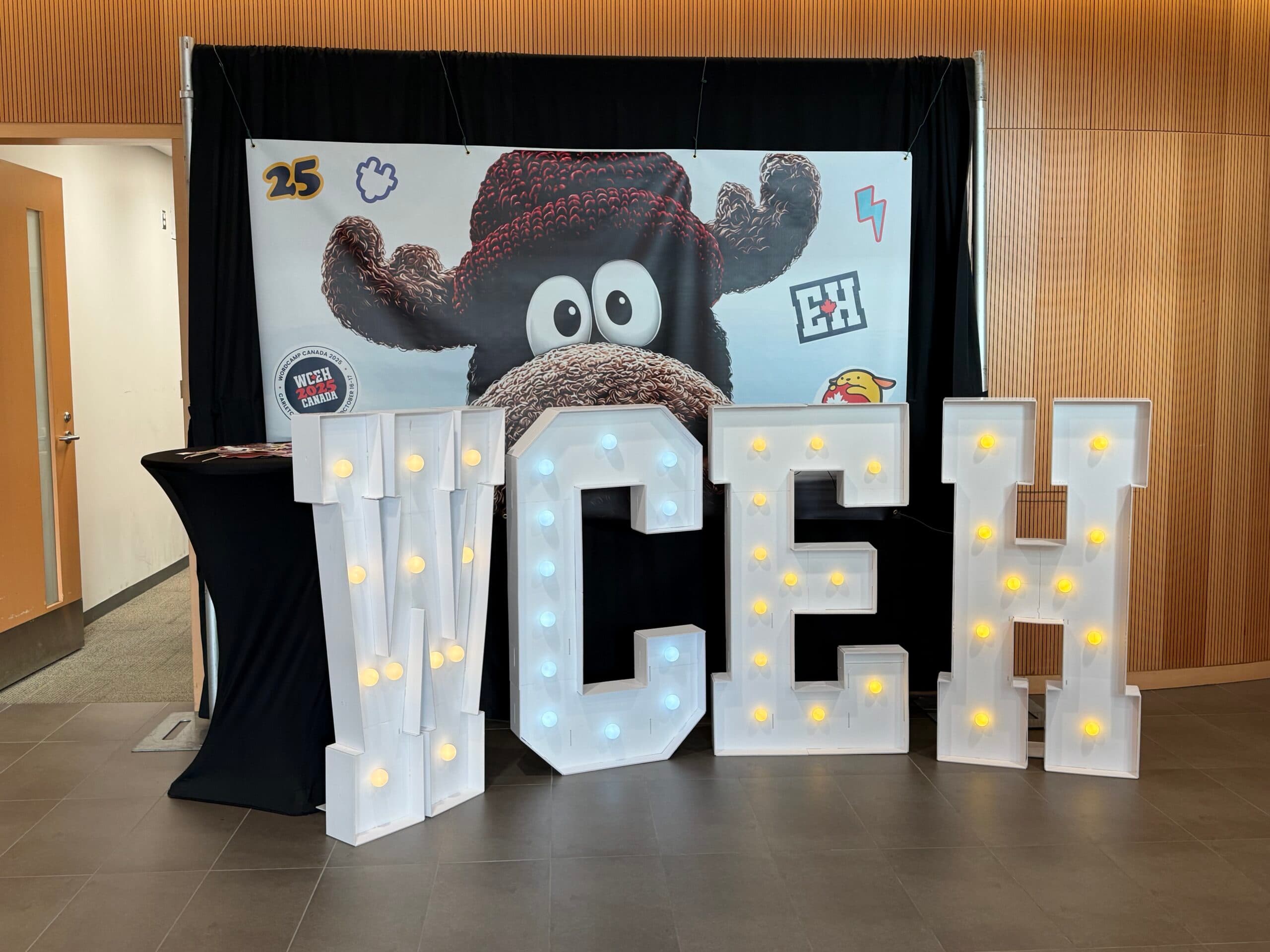WCEH large block letters in front of a WC Canada moose poster